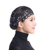 A black lace skull cap designed to be worn under a hijab scarf.