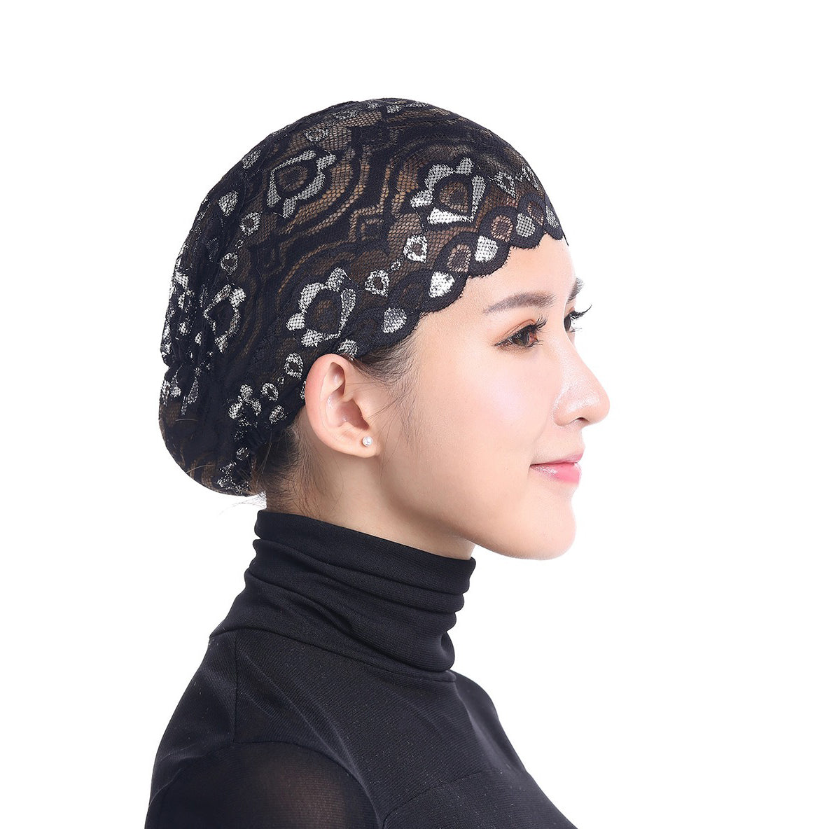 A black lace skull cap designed to be worn under a hijab scarf.