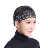 A black lace skull cap designed to be worn under a hijab scarf.
