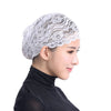 A white lace skull cap designed to be worn under a hijab scarf.