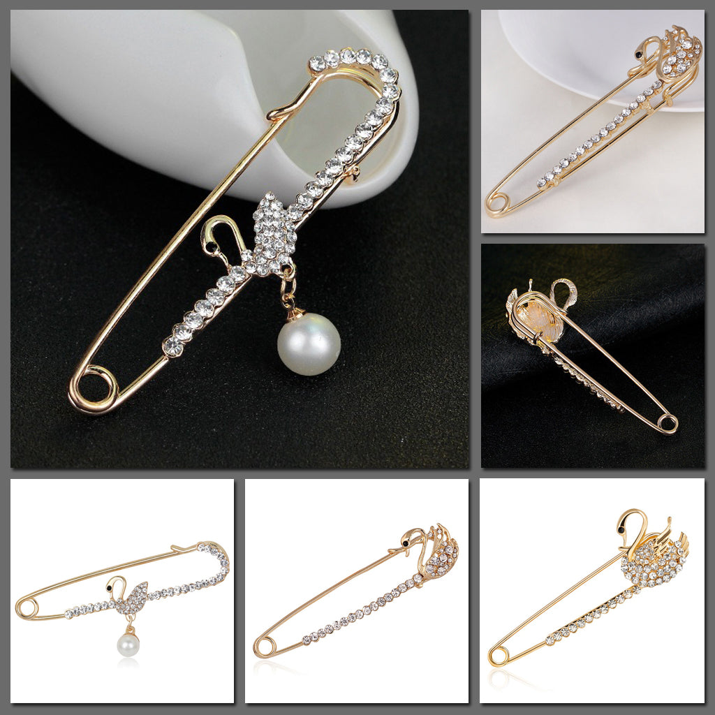 Scarf pins in assorted swan designs, gold colour with zircon crystals.