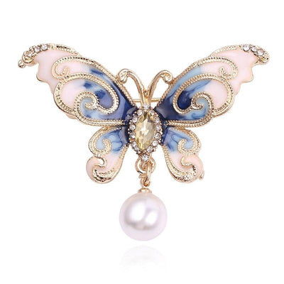 A lovely butterfly brooch with rhinestone crystal and pearls available in blue, green, and pink.