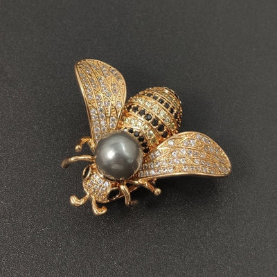 Queen Bee Deluxe Brooch - A beautiful bee brooch set with dozens of delicate crystals and a large pearl, available in gold or silver.
