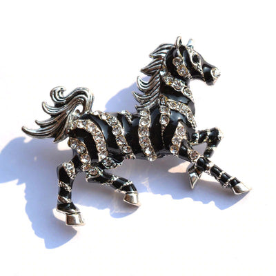 Zesty Zebra Brooch - A medium sized brooch shaped like a zebra running with its mane and tail flowing in the wind. It's available in gold or silver colours, and is studded with crystals.