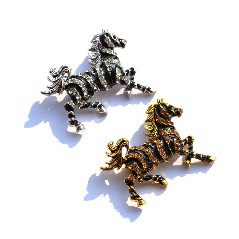 Zesty Zebra Brooch - A medium sized brooch shaped like a zebra running with its mane and tail flowing in the wind. It's available in gold or silver colours, and is studded with crystals. 
