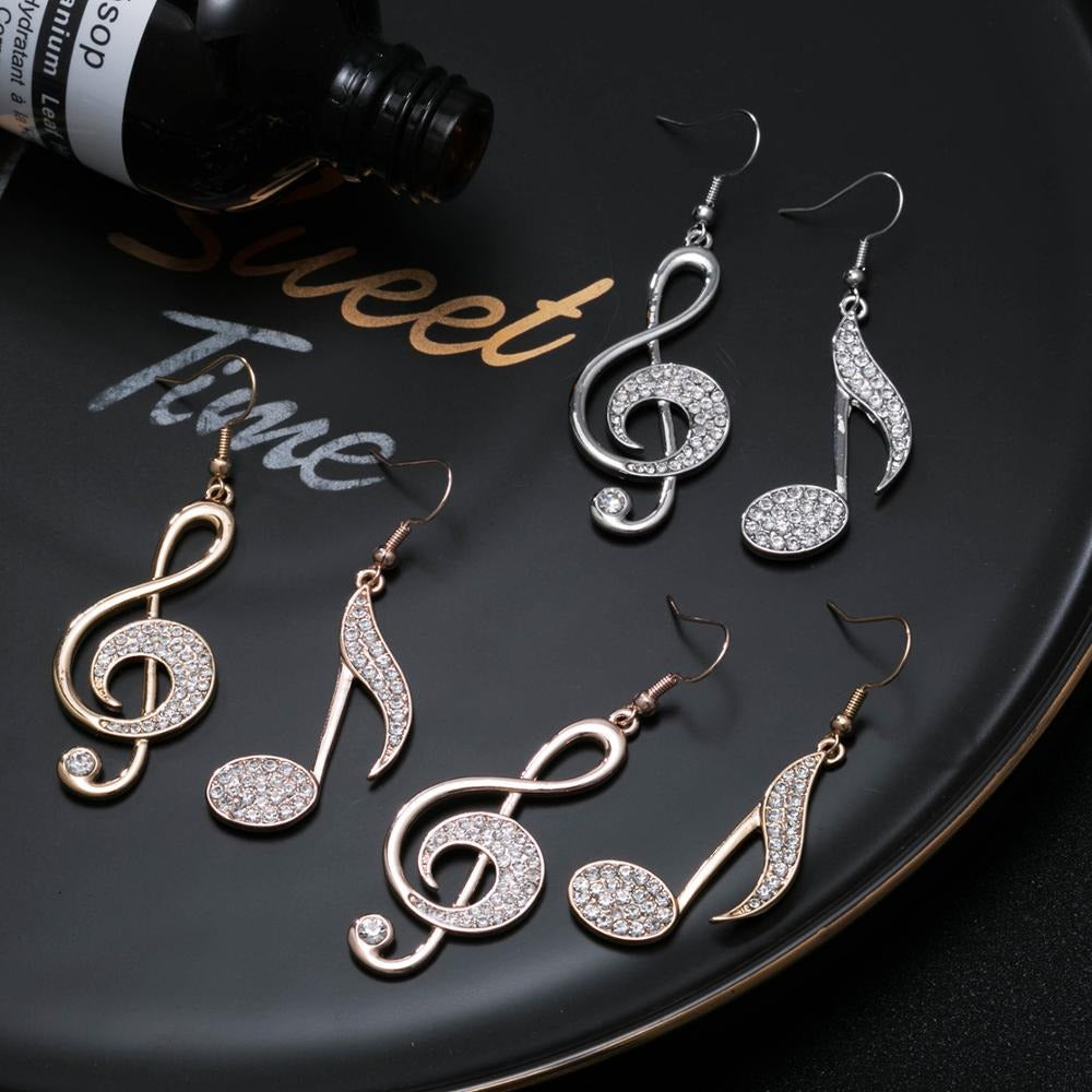 Aretha Asymmetrical Dangle Earrings - Large, elegant earrings featuring a different musical note on each ear, studded with beautiful crystals. 