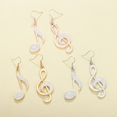 Aretha Asymmetrical Dangle Earrings - Large, elegant earrings featuring a different musical note on each ear, studded with beautiful crystals.
