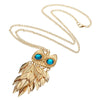 Athena Sweater Chain - A long golden chain with a stylised owl-themed pendant strung on it.