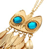 Athena Sweater Chain - A long golden chain with a stylised owl-themed pendant strung on it.