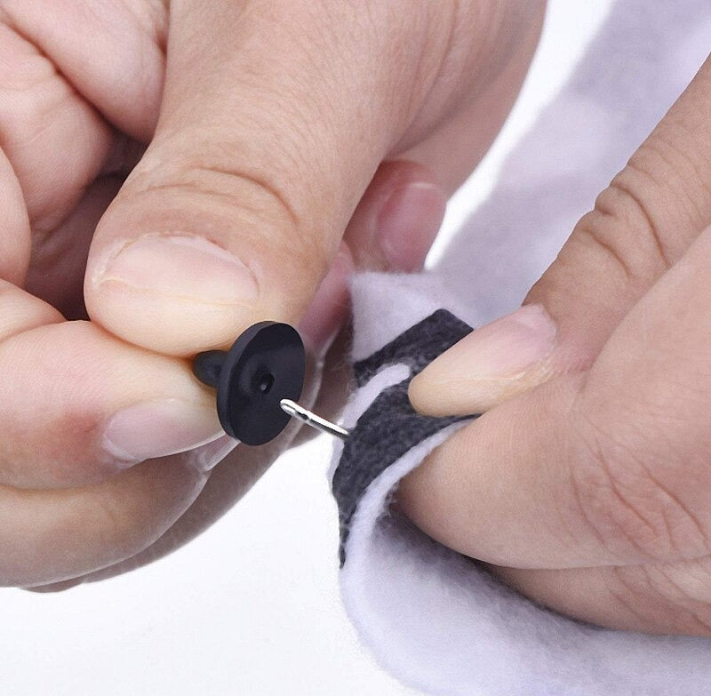 Loose Brooch Pin Backs - A black rubber brooch pin back showing its use. 