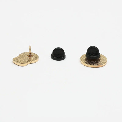 Loose Brooch Pin Backs - A black rubber brooch pin back showing its use.
