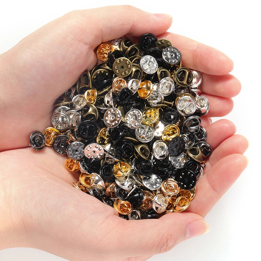 Loose Brooch Pin Backs - A pile of backs for brooches and enamel pins in lots of different colours.