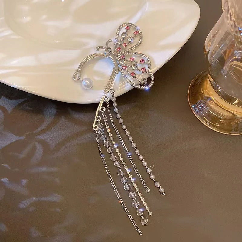 Cara Butterfly Ear Cuff - A large, sparkly earring designed to sit over the wearer's ear without needing any piercings.