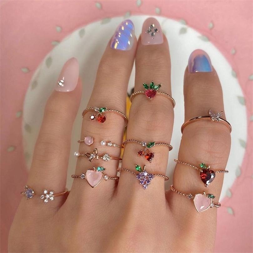 The Demeter Ring Set - Add some yummy sparkle to any outfit with the Demeter Ring Set! This set includes 11 adorable rings with a diverse fruit-and-flower theme and beautiful sparkling crystals across the board. 