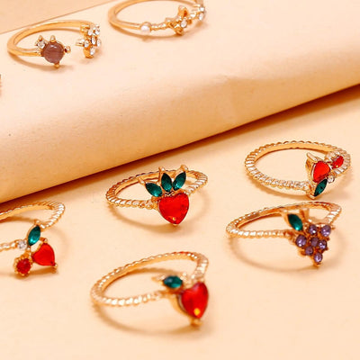 The Demeter Ring Set - Add some yummy sparkle to any outfit with the Demeter Ring Set! This set includes 11 adorable rings with a diverse fruit-and-flower theme and beautiful sparkling crystals across the board.