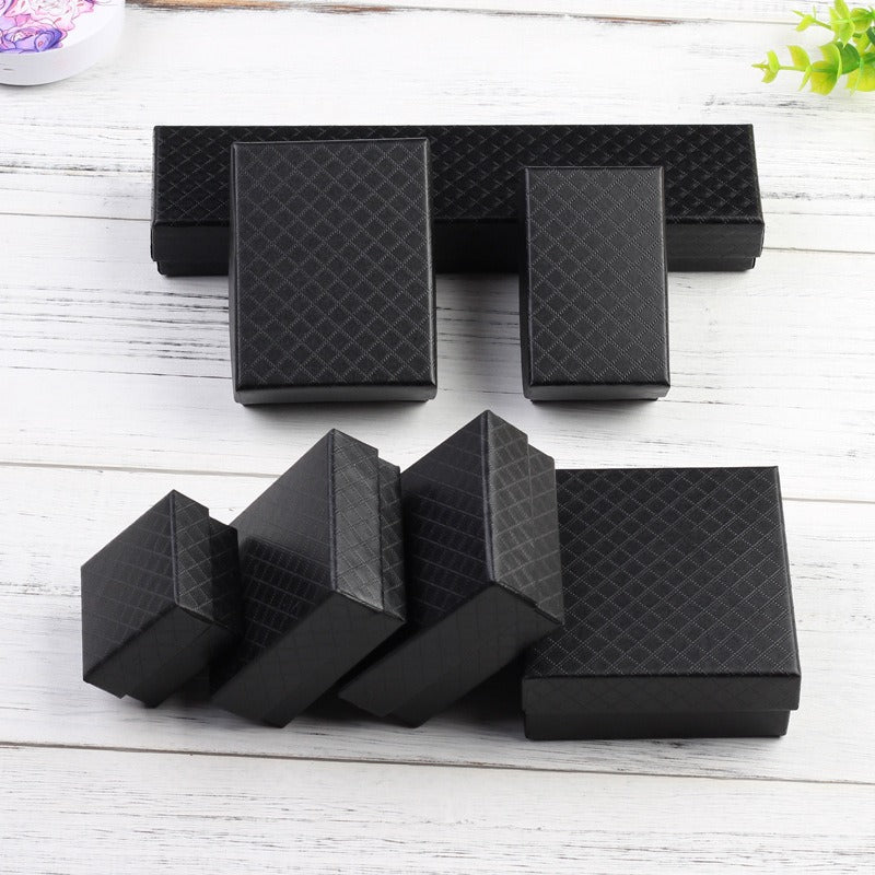 Diamond Embossed Jewellery Gift Box - An assortment of different sized gift boxes, which are made of black paper with a diamond lattice print embossed into it.