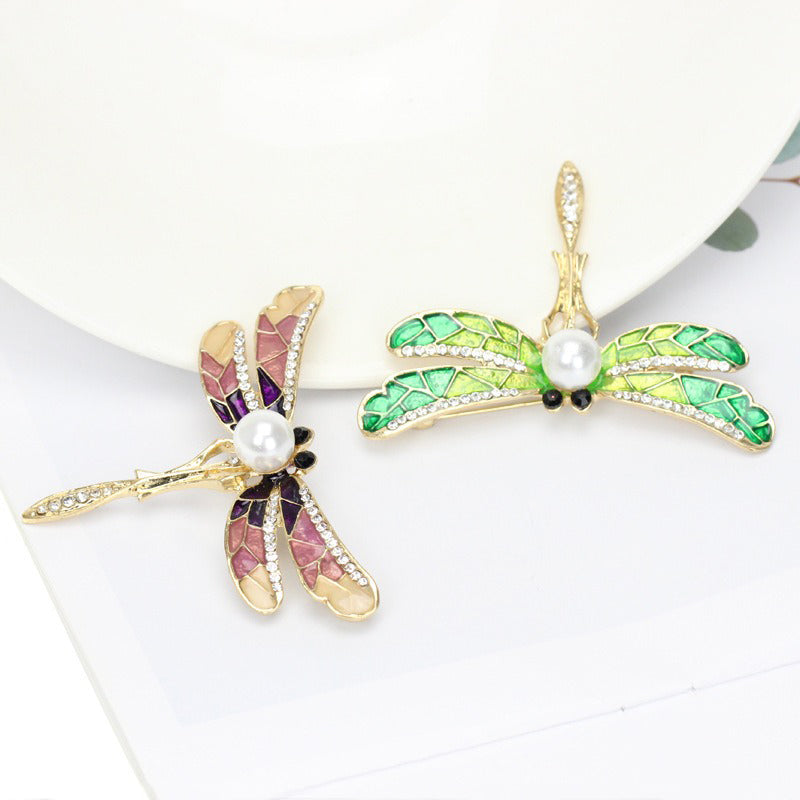 Estelle II Dragonfly Brooch - A large, elegant enamel brooch shaped like a dragonfly, with small crystals along the wings and a pearl on the body.