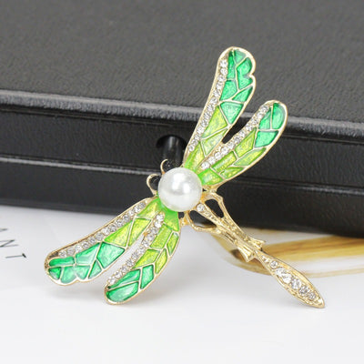 Estelle II Dragonfly Brooch - A large, elegant enamel brooch shaped like a dragonfly, with small crystals along the wings and a pearl on the body.