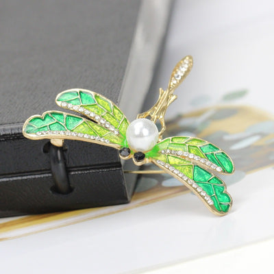 Estelle II Dragonfly Brooch - A large, elegant enamel brooch shaped like a dragonfly, with small crystals along the wings and a pearl on the body.