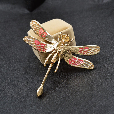 Etain Oversized Dragonfly Brooch - An extremely large brooch shaped like a stylised dragonfly, with a large coloured crystal on its back and translucent, colourful wings.