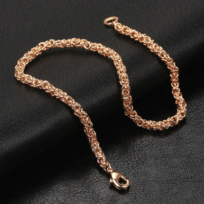 Eudocia Byzantine Weave Bracelet - A delicate rose gold bracelet made from a complicated weave of interlocking rings.