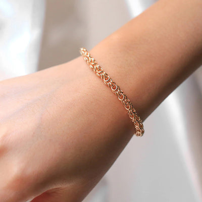 Eudocia Byzantine Weave Bracelet - A delicate rose gold bracelet made from a complicated weave of interlocking rings.