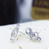 Florence Treble Clef Stud Earrings - Tiny, adorable stud earrings shaped like musical notes, studded with small gemstones.