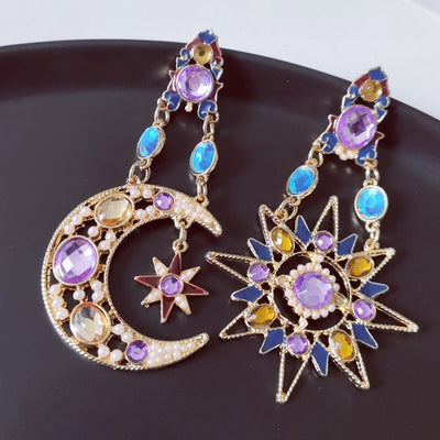 The Hypatia Earrings - A large, gold-coloured pair of earrings studded with artificial crystals, in a beautiful star and moon motif.