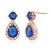 Imogen Luxury Crystal Dangle Earrings - Vintage-style earrings with a teardrop-shaped dark blue stone surrounded by little white stones, and a round stone on the lobe.