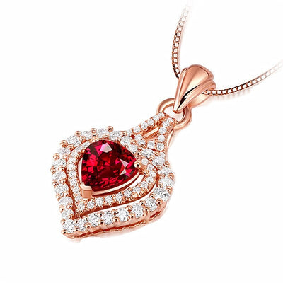 Juliette Luxury Crystal Pendant - A shimmering heart-shaped pendant featuring a large trilliant cut red topaz, surrounded by tiny white quartz in a heart shape.