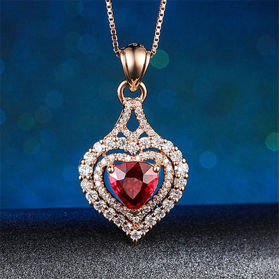 Juliette Luxury Crystal Pendant - A shimmering heart-shaped pendant featuring a large trilliant cut red topaz, surrounded by tiny white quartz in a heart shape.