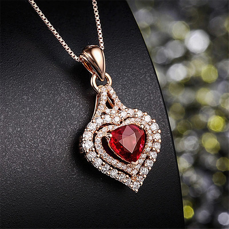 Juliette Luxury Crystal Pendant - A shimmering heart-shaped pendant featuring a large trilliant cut red topaz, surrounded by tiny white quartz in a heart shape.