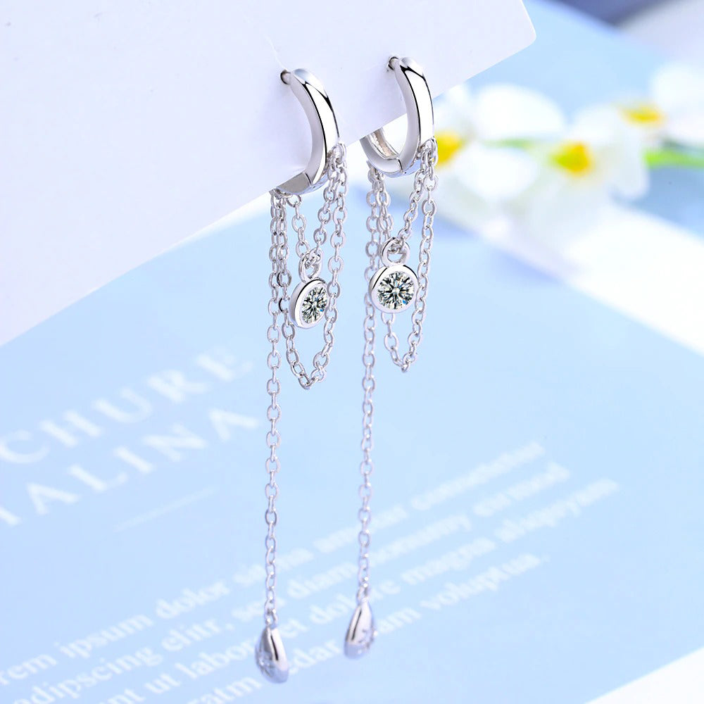 Lucyna Tassel Chain Lever Back Earrings - Small, delicate silver huggies with three chains suspended from them, two of which have little charms attached.