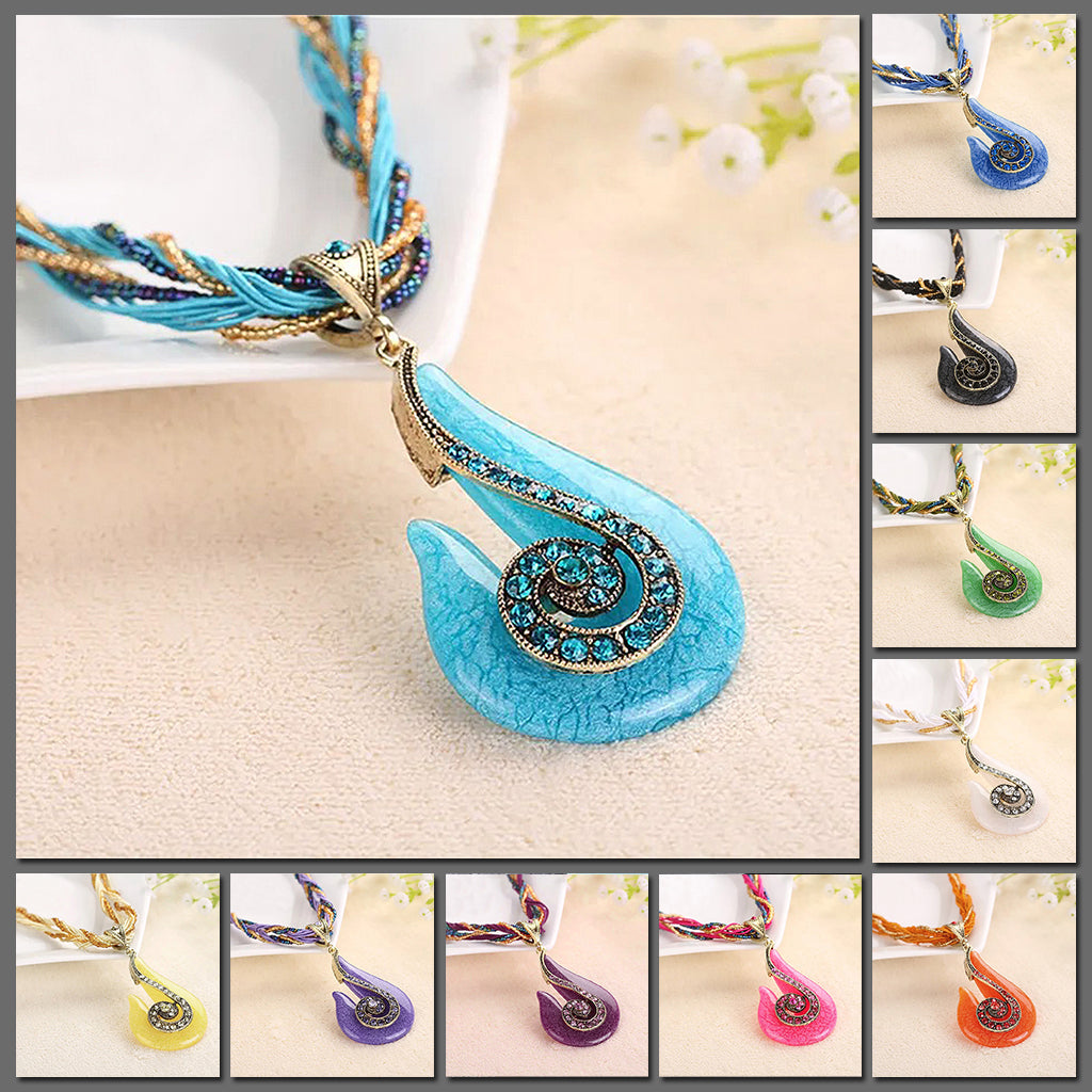 Manaia Beaded Statement Necklace - A chunky, hook-shaped resin pendant studded with matching crystals, strung from a leatherette strand and bead necklace.