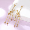 The Marionette Dancing Skeleton Earrings - Large Halloween earrings decorated with partially articulated skeletons, available in gold or silver coloured.