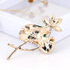 Mika Enamel Lotus Brooch - A lovely colourful brooch with a green metallic lily pad, a flower constructed of marquise cut pink crystals, and delicate pave-style crystals along the underside of the leaf.