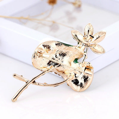 Mika Enamel Lotus Brooch - A lovely colourful brooch with a green metallic lily pad, a flower constructed of marquise cut pink crystals, and delicate pave-style crystals along the underside of the leaf.