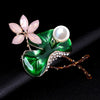 Mika Enamel Lotus Brooch - A lovely colourful brooch with a green metallic lily pad, a flower constructed of marquise cut pink crystals, and delicate pave-style crystals along the underside of the leaf.