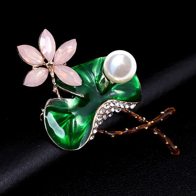 Mika Enamel Lotus Brooch - A lovely colourful brooch with a green metallic lily pad, a flower constructed of marquise cut pink crystals, and delicate pave-style crystals along the underside of the leaf.