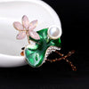 Mika Enamel Lotus Brooch - A lovely colourful brooch with a green metallic lily pad, a flower constructed of marquise cut pink crystals, and delicate pave-style crystals along the underside of the leaf.