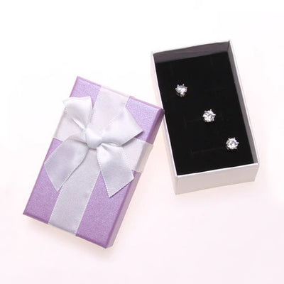 Purple & White Bow Gift Box - A small paperboard box that is light purple on the top, white underneath, and has a small white ribbon glued to the top.