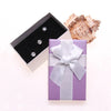 Purple & White Bow Gift Box - A small paperboard box that is light purple on the top, white underneath, and has a small white ribbon glued to the top.