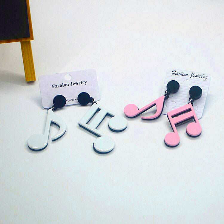 Retro Revival Notable Notes Earrings - Large asymmetrical acrylic earrings shaped like oversized musical notes, available in pink or white.