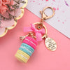 Teenytopia Oh Là Là Macaron Key Chain - An adorable, ultra-femme key chain featuring a stack of colourful macarons, a trinket of the eiffel tower, and a small oval with a phrase on it.