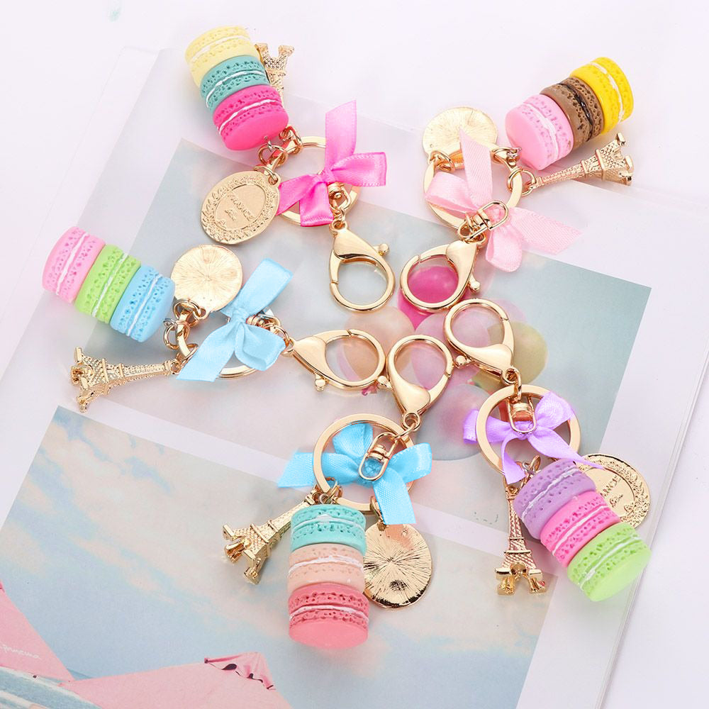 Teenytopia Oh Là Là Macaron Key Chain - An adorable, ultra-femme key chain featuring a stack of colourful macarons, a trinket of the eiffel tower, and a small oval with a phrase on it.