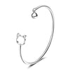 Tinklebell Silver Cat Bell Bangle - A delicate silver bracelet with a cat-shaped charm on one and and a small silver bell on the other.