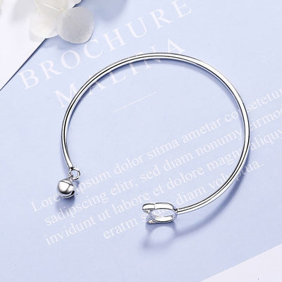 Tinklebell Silver Cat Bell Bangle - A delicate silver bracelet with a cat-shaped charm on one and and a small silver bell on the other.