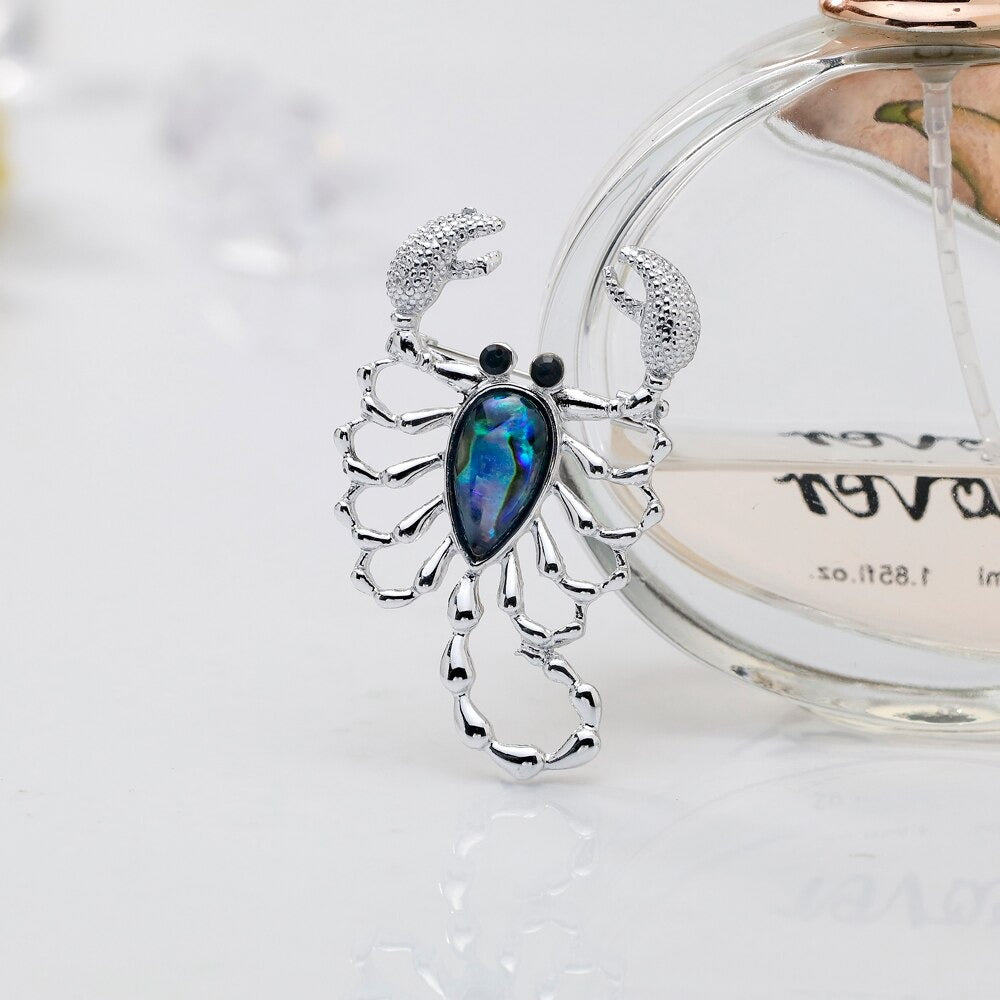 The Tropicana Kopiana Brooch - A beautiful silver-toned zinc alloy scorpion brooch adorned with crystals and polished paua shell.