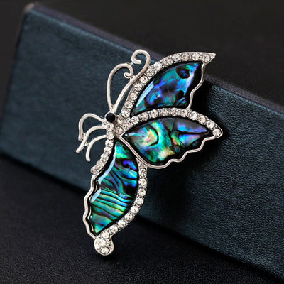 The Tropicana Leilani Brooch - A beautiful silver-toned zinc alloy butterfly brooch adorned with crystals and polished paua shell.