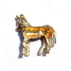 Zealous Zebra Brooch - A medium sized brooch shaped like a zebra standing still and looking forward, with a gold and black enamel background and studded with small crystals.